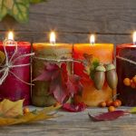 Burning Candles on Wooden Table Decorated for Fall