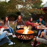 Friends sitting around a backyard fire